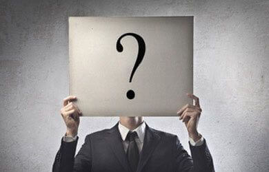 person holding up a question mark sign